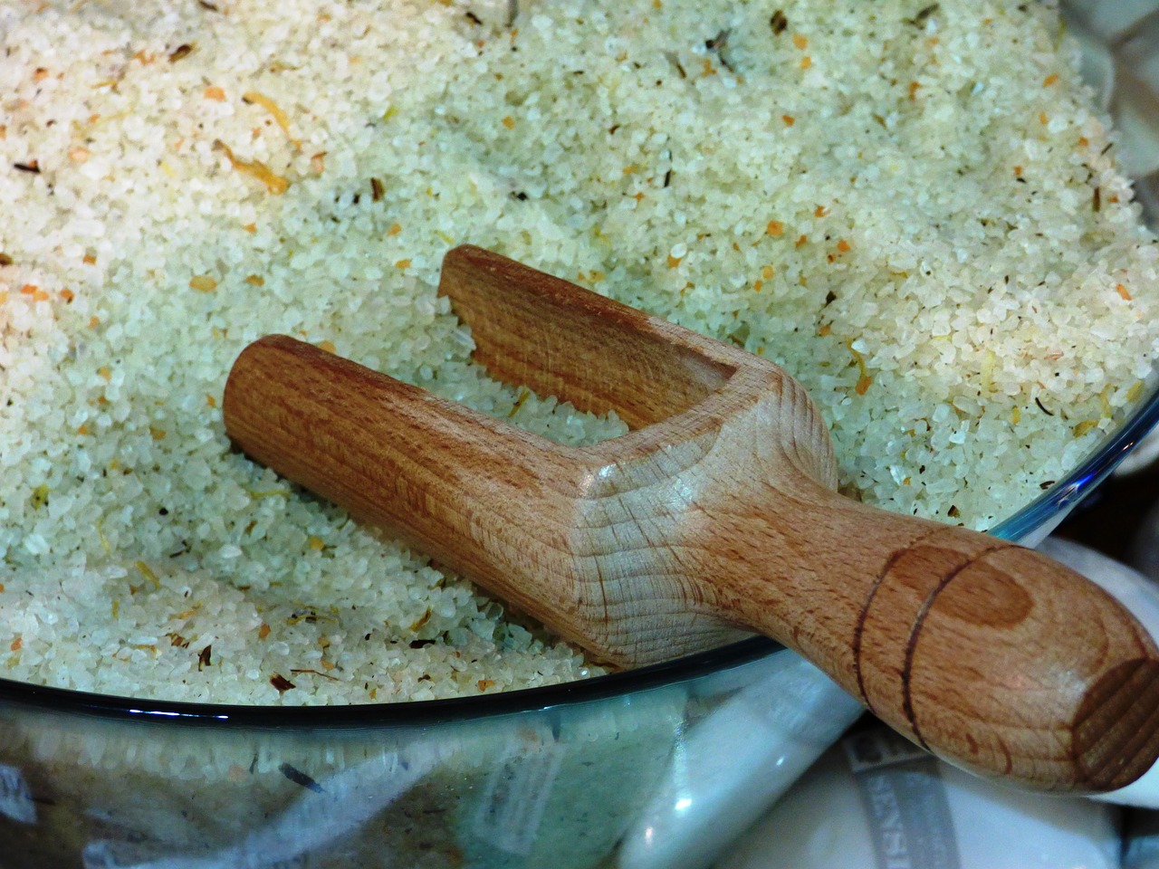 ガラスのボウルいっぱいのハーブソルトと木製のスコップ